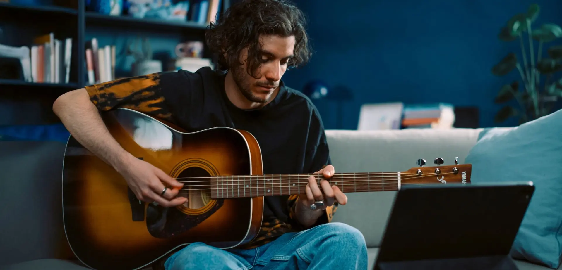 Una persona che suona una chitarra acustica